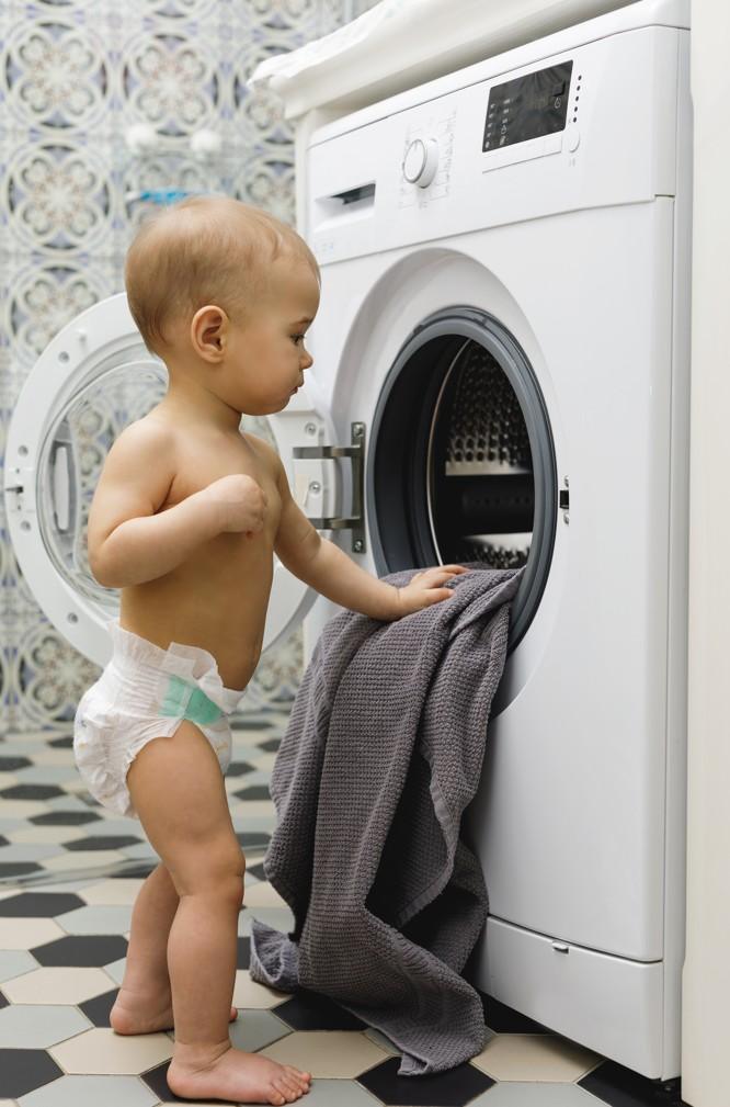 broken washing machine baby looking inside