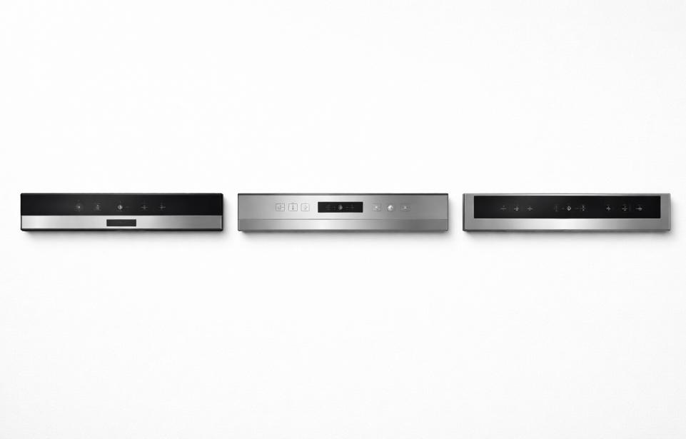 A flat lay overhead shot of three dishwasher control panels side by side on a clean white surface, representing three different quality tiers, subtle branding-neutral designs, modern and minimal aesthetic, soft studio lighting, realistic product photography style, no text or logos.